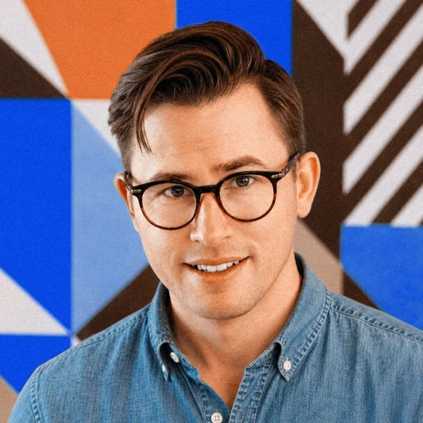 Jeremiah Berkheimer, founder of Pact Haus, in front of a painted wall